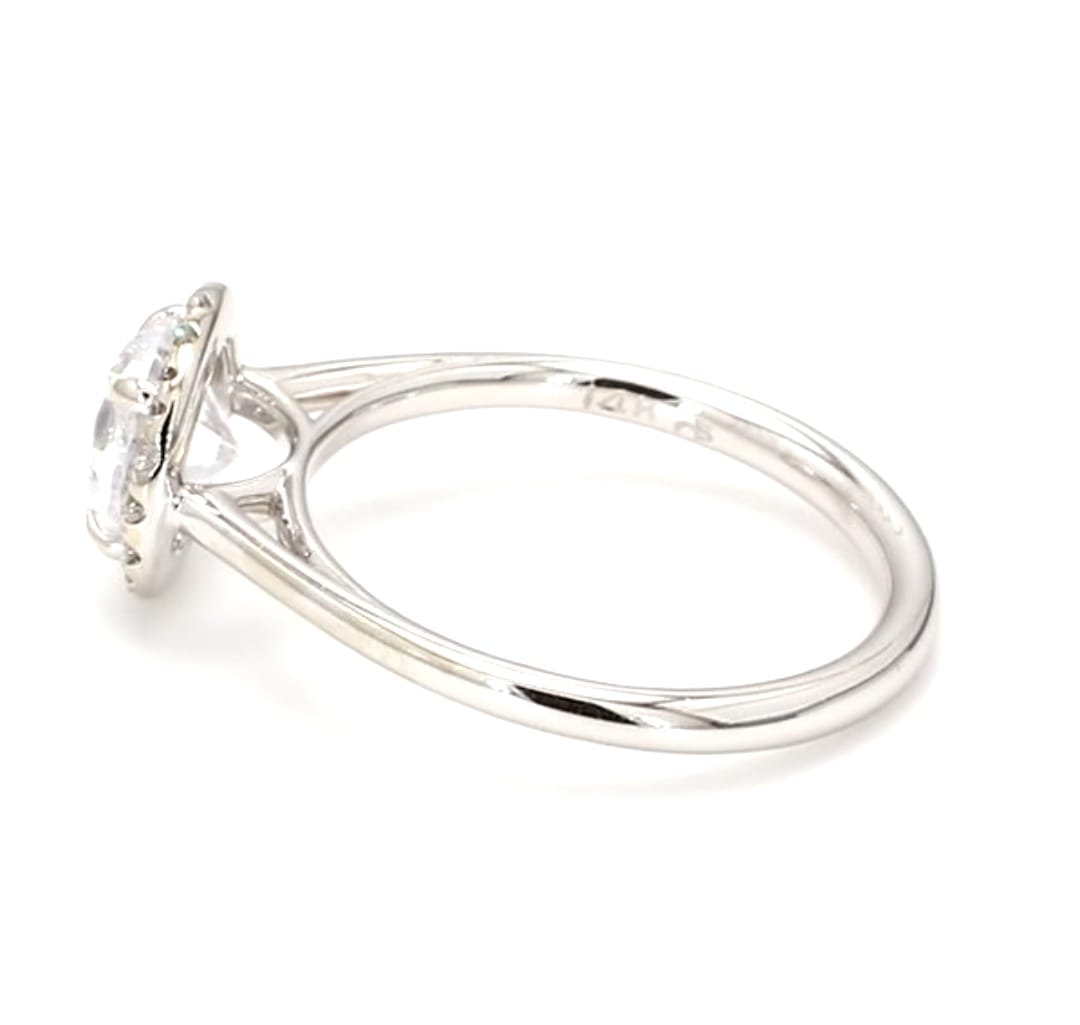 Side profile view of a 2 carat round lab grown diamond engagement ring with halo setting