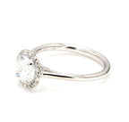 Angled shot of a 2 carat round brilliant lab diamond ring with sparkling pave halo