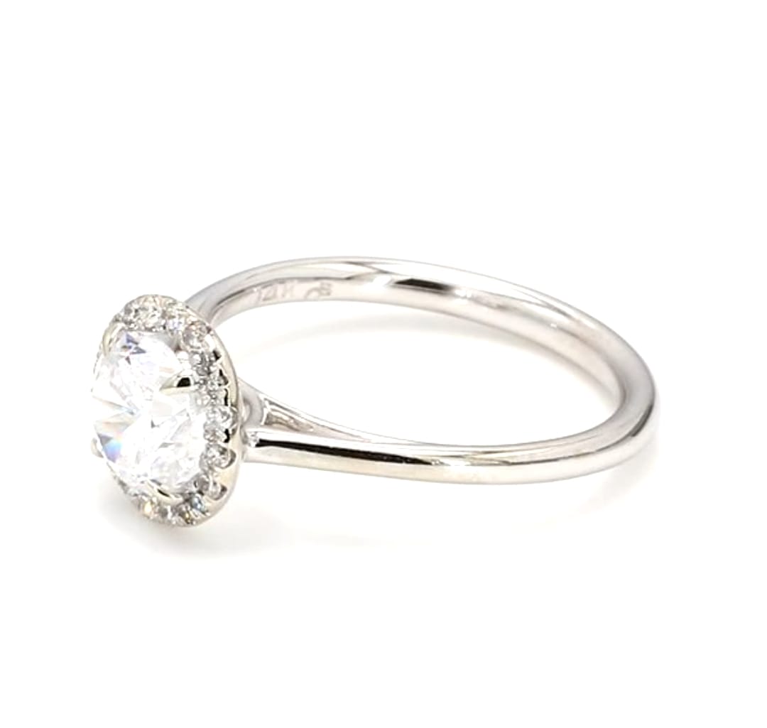 Angled shot of a 2 carat round brilliant lab diamond ring with sparkling pave halo