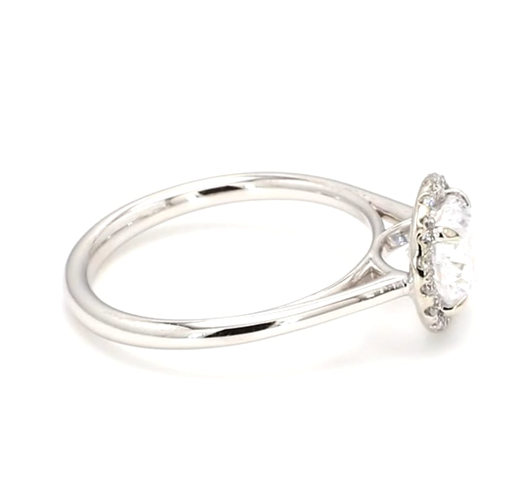 Side angle view showing polished solid plain band and diamond halo head profile
