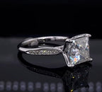 Angled shot showing pavé diamond accents on a 3ct princess cut white gold ring