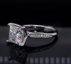 Three-quarter view of white gold 3 carat princess cut lab diamond ring on dark surface