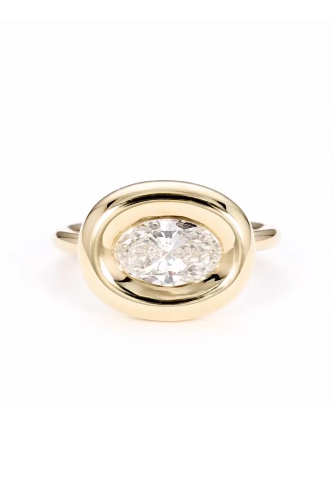 Top view of 2 CT east-west oval cut lab grown diamond ring in yellow gold chunky bezel setting