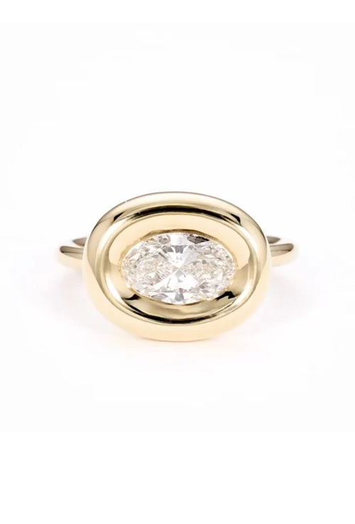 Top view of 2 CT east-west oval cut lab grown diamond ring in yellow gold chunky bezel setting