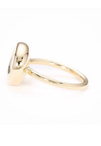 Side profile of yellow gold bezel engagement ring showing smooth rounded bezel collar