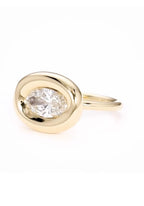 Three-quarter view of horizontal 2 carat oval lab diamond ring in chunky yellow gold bezel