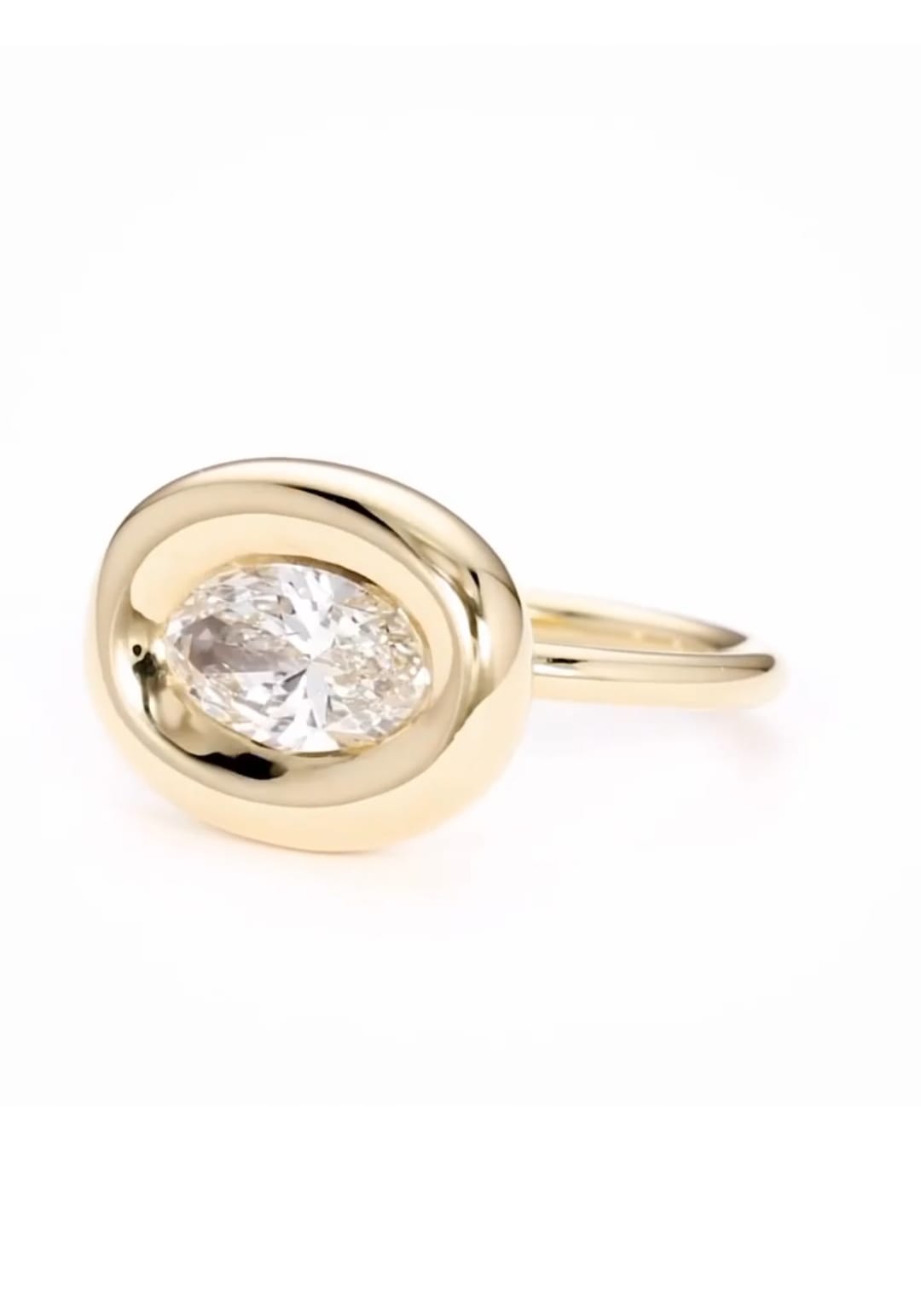 Three-quarter view of horizontal 2 carat oval lab diamond ring in chunky yellow gold bezel