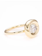 Close-up side profile showing polished gold bezel surround and 2 CT lab diamond center stone