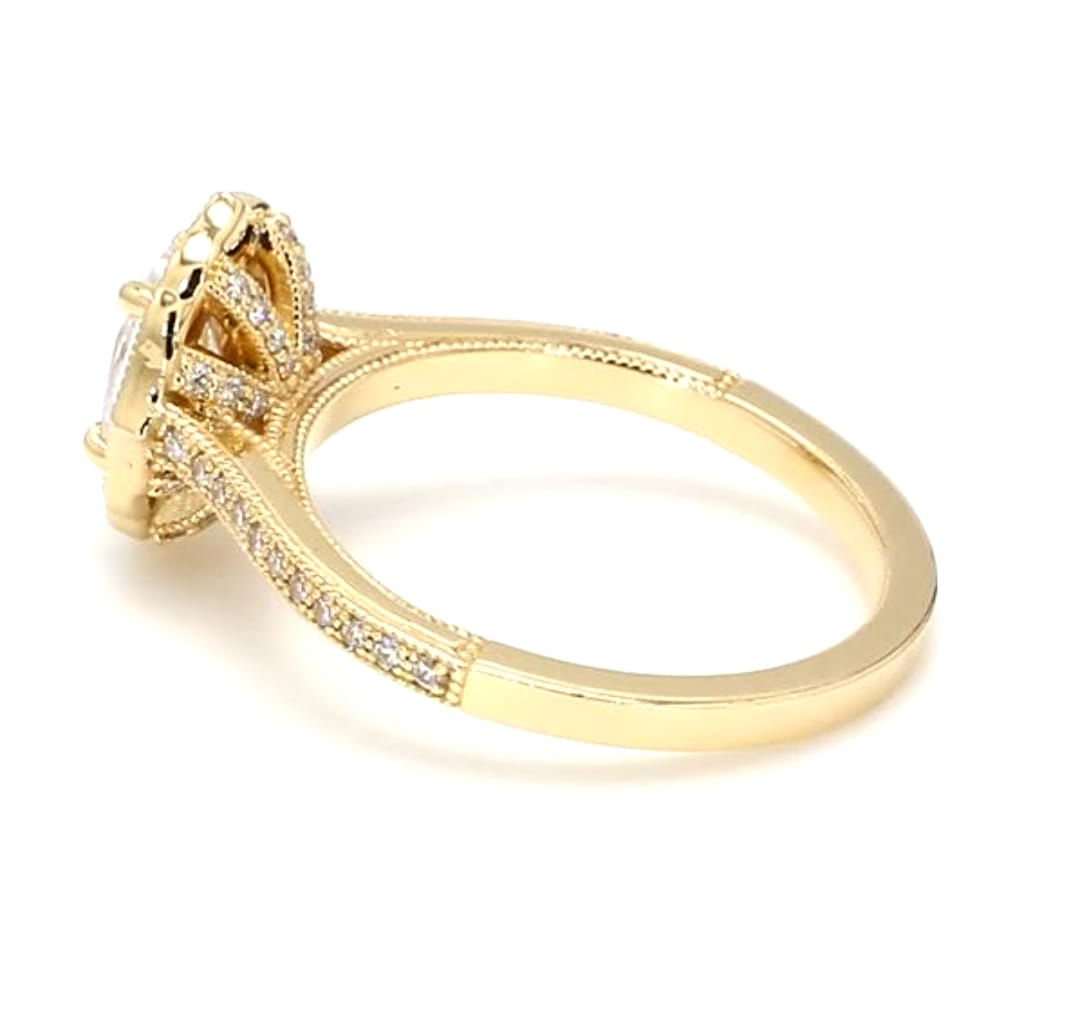 Side profile of yellow gold 2 CT oval lab diamond ring showing pave band and milgrain border