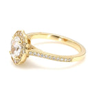 Close-up side profile of 2 carat oval diamond ring showing scalloped halo and basket setting