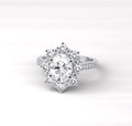 Top-down view of a 2 carat oval cut vintage halo diamond engagement ring showing the full sunburst design.