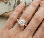 Top-down view of a woman's hand wearing a stunning rose gold vintage halo engagement ring, showcasing its size and proportions.