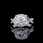 Top-down view of a 2 CT cushion cut lab grown diamond ring with a halo and twisted band, reflected on a black surface.