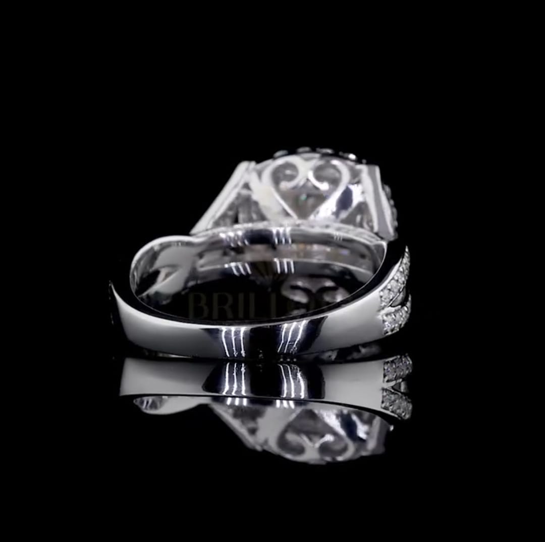 Back profile view of the diamond engagement ring revealing the intricate, romantic heart design in the under-gallery.