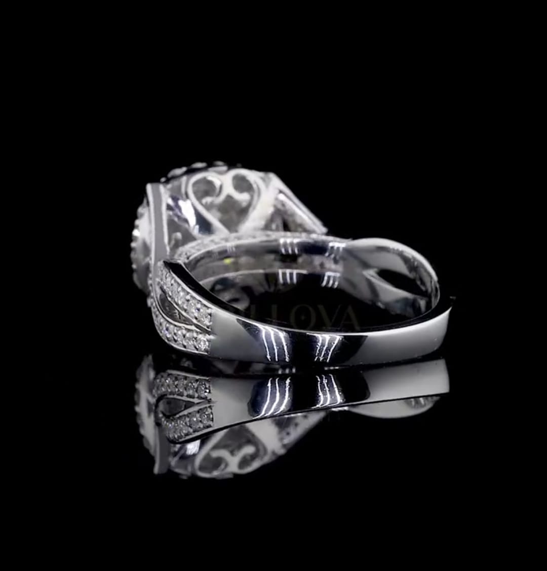 Lower back angle view of the cushion cut halo ring showcasing the detailed scroll and heart motifs beneath the center stone.