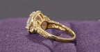 Angled back profile view of a 2ct oval lab grown diamond halo ring highlighting the side diamonds and engraved shank.