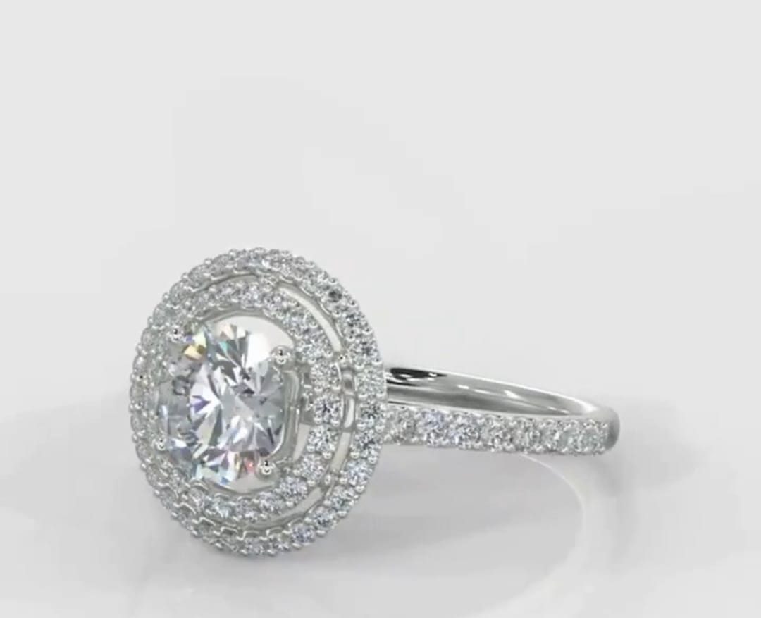 Angled top view of a white gold 3 carat round lab grown diamond engagement ring with a double halo setting.