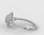 Side profile of a round cut double halo engagement ring showing the elevated prong setting and pave diamond band.