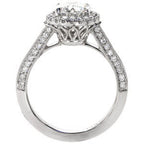 Side profile view of a round diamond halo ring displaying an intricate open-work filigree gallery and cathedral shoulders.