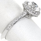 Angled view of a 3 carat lab grown diamond engagement ring highlighting the pave set diamonds, milgrain edges, and detailed basket.