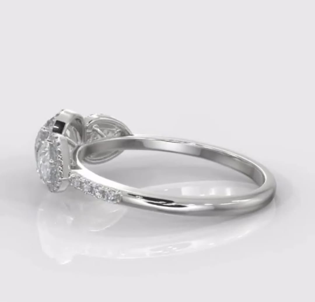 Side profile of a 2 carat round and pear three-stone diamond ring showcasing its elegant low-profile setting.