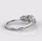 Angled back view of a white gold or platinum engagement ring featuring three halo-set lab grown diamonds.
