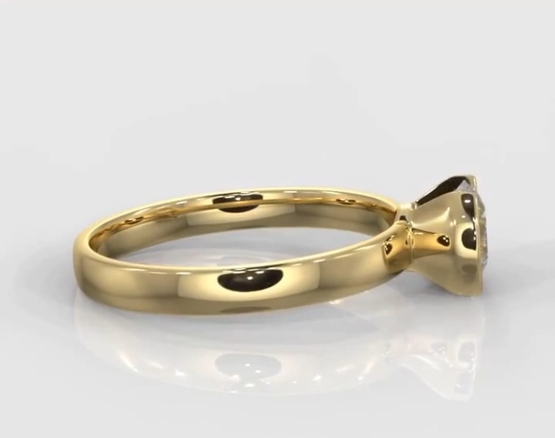 Side view of a modern yellow gold engagement ring highlighting the secure semi-bezel diamond setting.