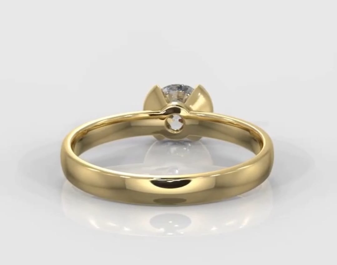Back view of a yellow gold engagement ring showing the open gallery of the half-bezel setting.