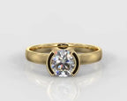 Top-down front view of a stunning 1.5 CT round cut lab grown diamond in a sleek half-bezel yellow gold ring.