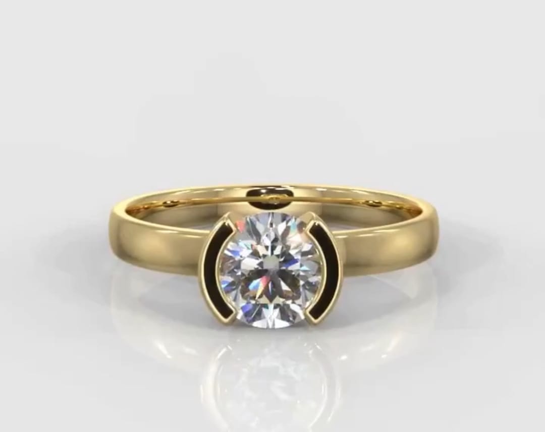 Top-down front view of a stunning 1.5 CT round cut lab grown diamond in a sleek half-bezel yellow gold ring.