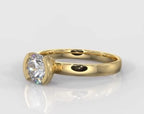 Angled front view of a modern half-bezel 1.5 carat round lab grown diamond solitaire engagement ring.