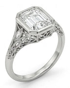 Angled view of a 5 carat emerald cut lab grown diamond engagement ring featuring a vintage filigree band.