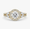 Top-down view of a 2 CT round cut lab grown diamond featuring a diamond halo and marquise cut side stones in yellow gold.