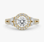 Top-down view of a 2 CT round cut lab grown diamond featuring a diamond halo and marquise cut side stones in yellow gold.