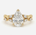 Top view of a 3 carat pear cut lab grown diamond engagement ring featuring a nature-inspired twisted vine band in yellow gold.