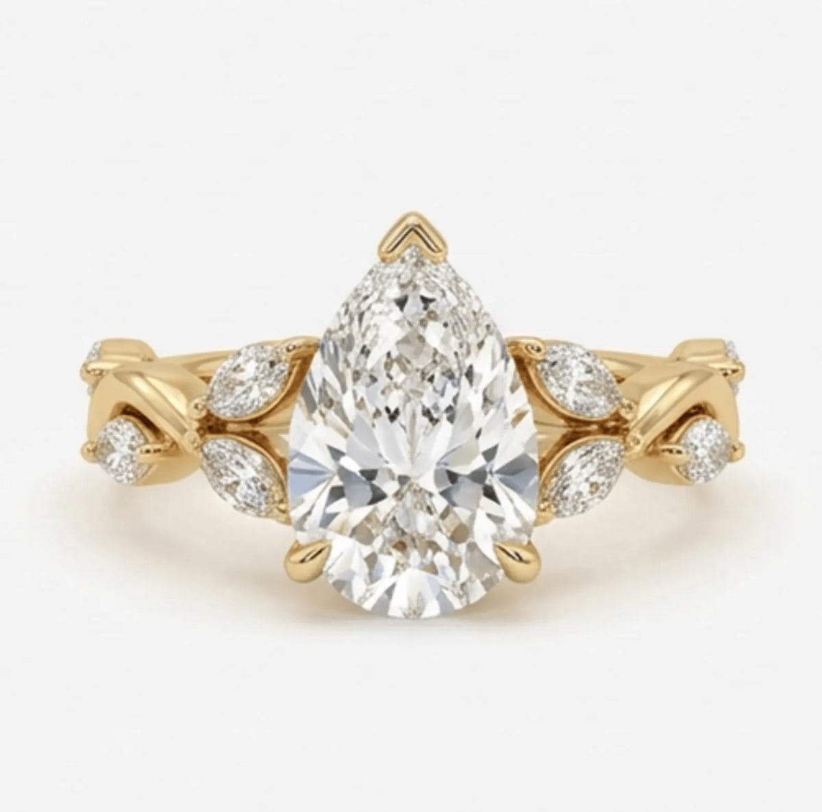 Top view of a 3 carat pear cut lab grown diamond engagement ring featuring a nature-inspired twisted vine band in yellow gold.