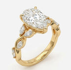 Angled view of a yellow gold pear cut lab diamond ring showcasing an intertwining band with marquise cut diamond leaf accents.