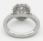 Under-gallery view of a white gold diamond engagement ring showing intricate filigree scrollwork and an engraved band beneath the center stone.