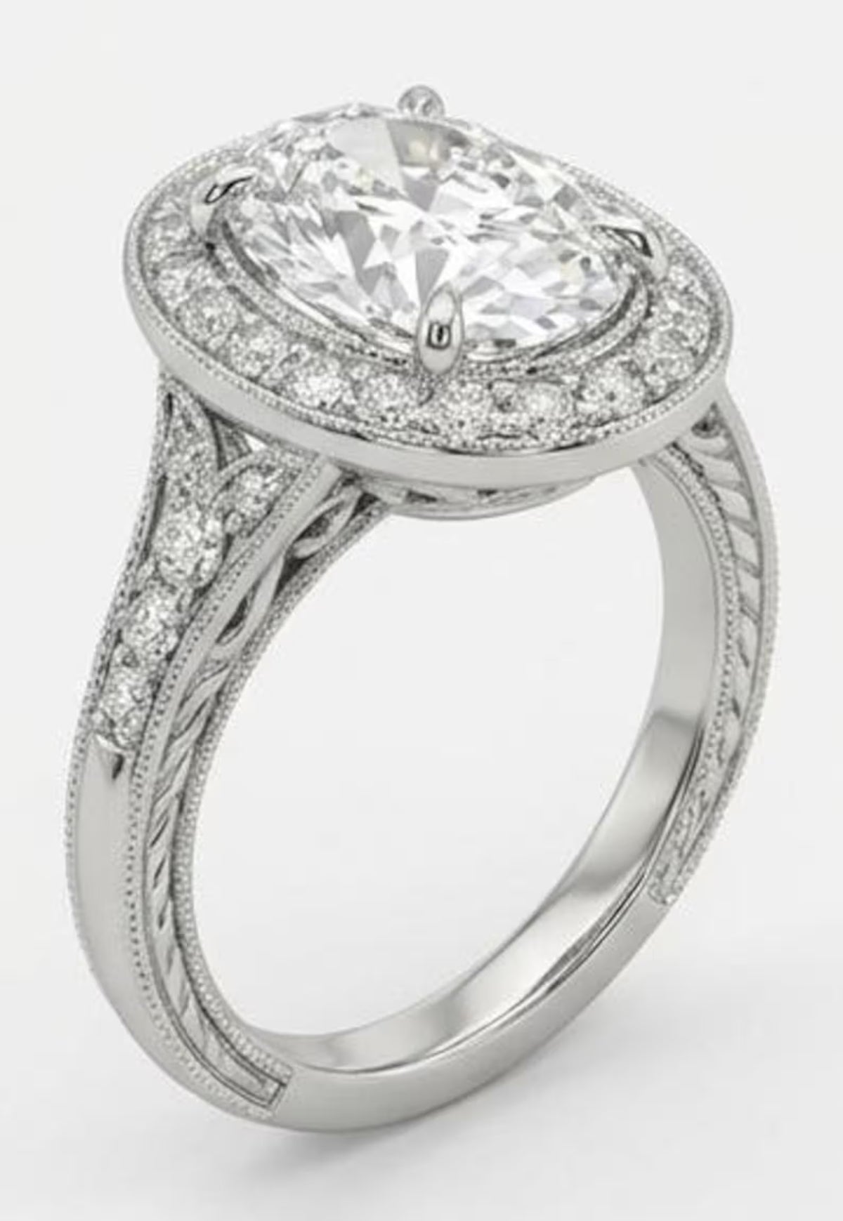 Angled view of a vintage style oval lab grown diamond ring featuring a pave diamond band and milgrain edges in white gold.