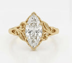 Top-down view of a 3 carat marquise cut lab grown diamond ring with carved botanical leaf accents in yellow gold.