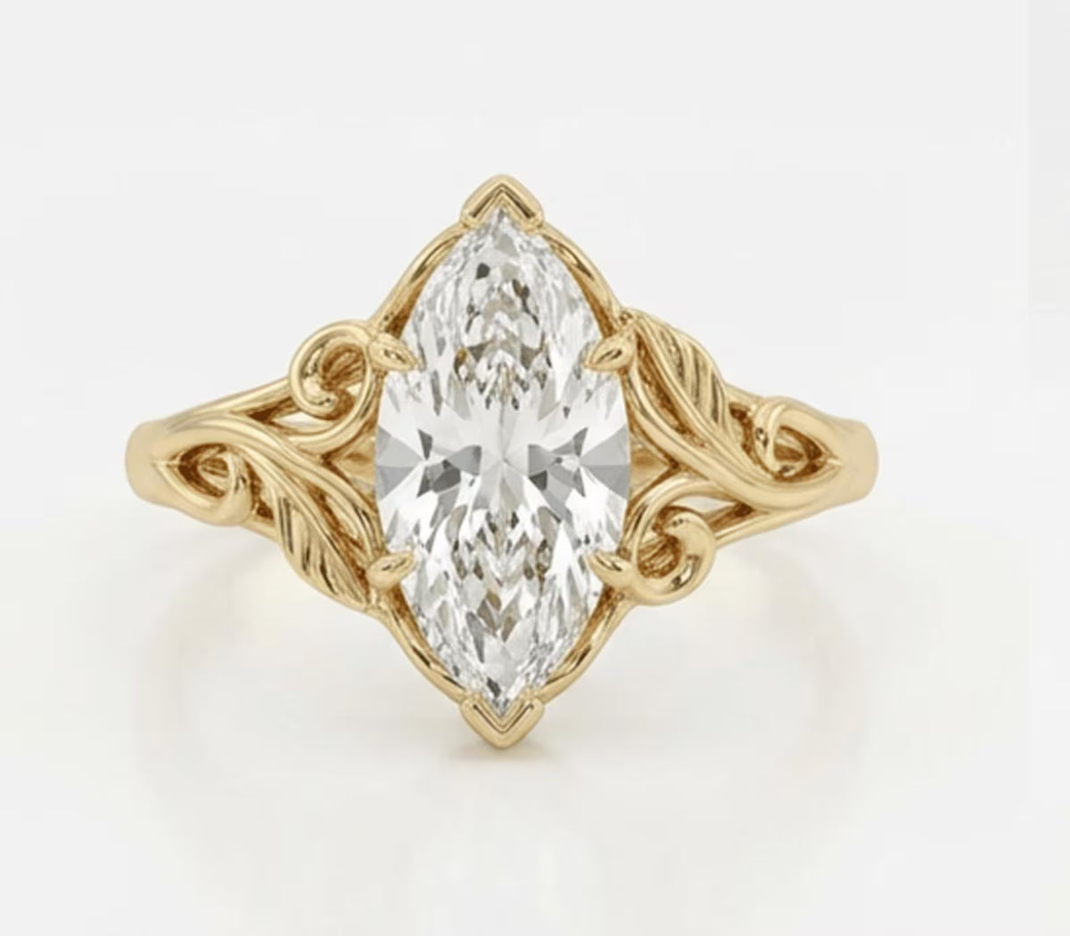 Top-down view of a 3 carat marquise cut lab grown diamond ring with carved botanical leaf accents in yellow gold.
