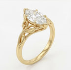Angled perspective of a marquise cut lab grown diamond engagement ring in yellow gold with nature-inspired leaf carving.
