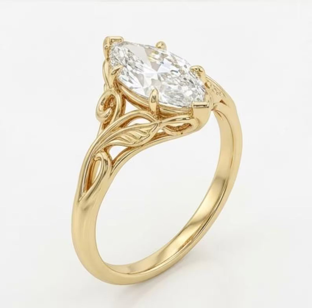 Angled perspective of a marquise cut lab grown diamond engagement ring in yellow gold with nature-inspired leaf carving.