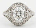 Top-down view of a 3 CT oval cut lab grown diamond set in an ornate vintage bezel filigree mounting.