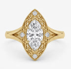 Top-down view of a 2 CT marquise cut lab grown diamond ring in yellow gold with an ornate filigree halo and milgrain borders.