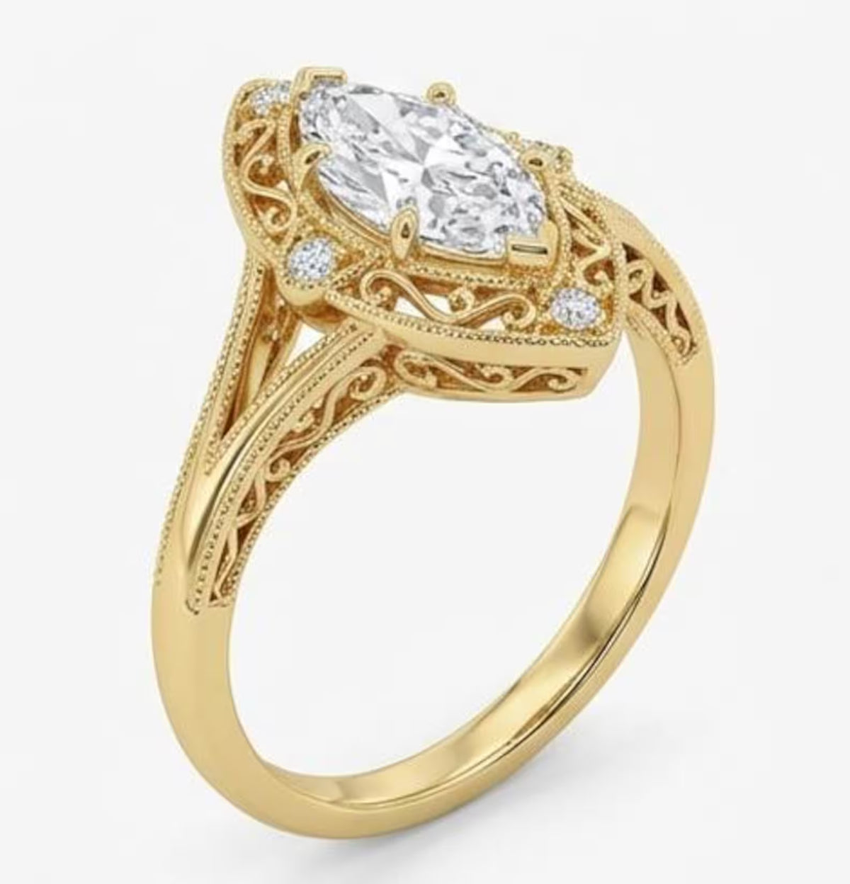 Perspective view of a yellow gold vintage marquise lab diamond engagement ring showing side scrollwork and split-shank band.