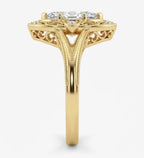 Side profile view of a yellow gold marquise lab grown diamond ring displaying cathedral split shank and milgrain edges.