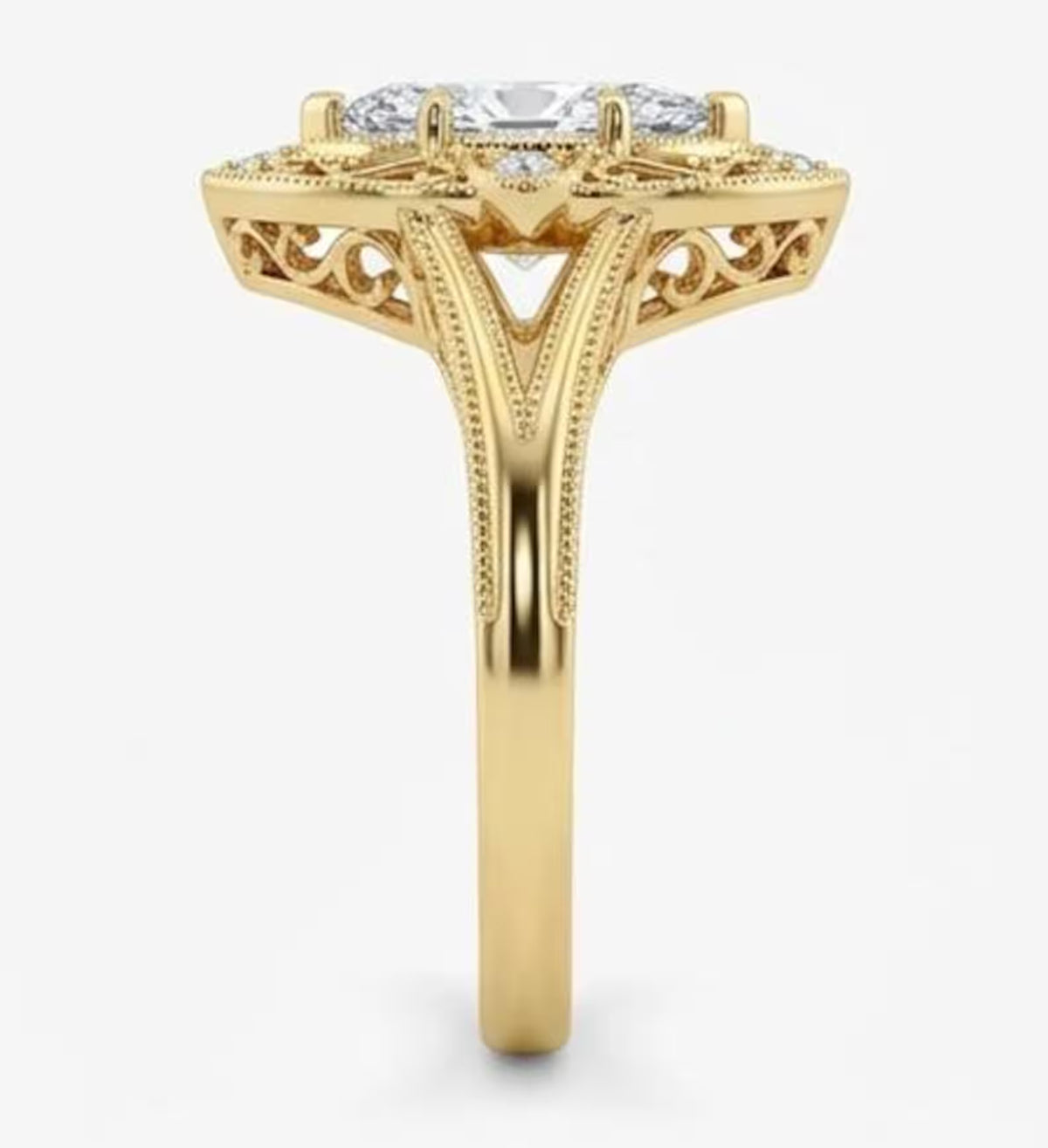 Side profile view of a yellow gold marquise lab grown diamond ring displaying cathedral split shank and milgrain edges.