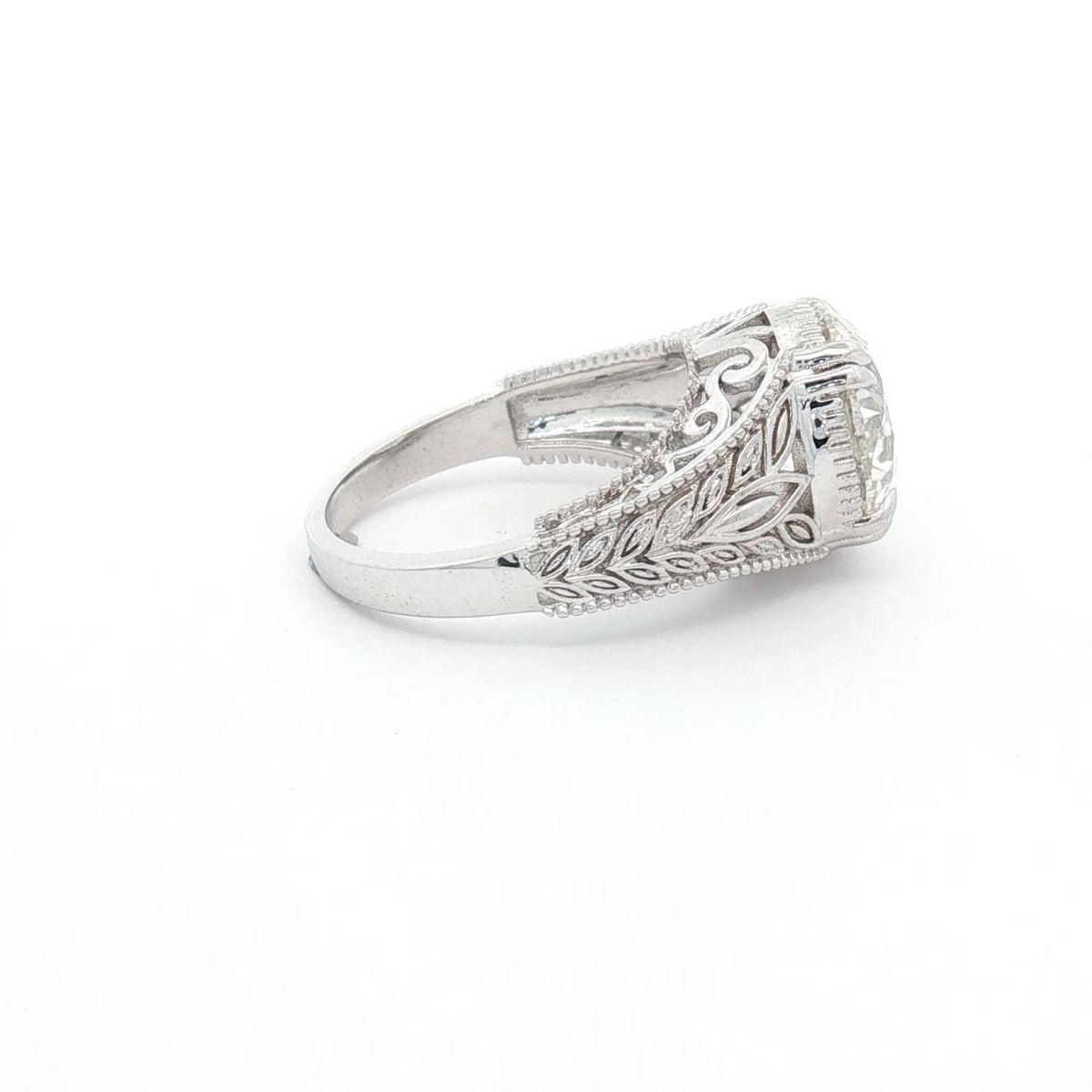 Side view showing the detailed carved leaf pattern running along the ring's shank.