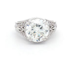 Top-down view displaying a brilliant 4 CT round lab grown diamond surrounded by leaf shoulders.